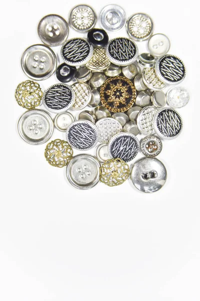 metal buttons of different shape and size on the white backgroun