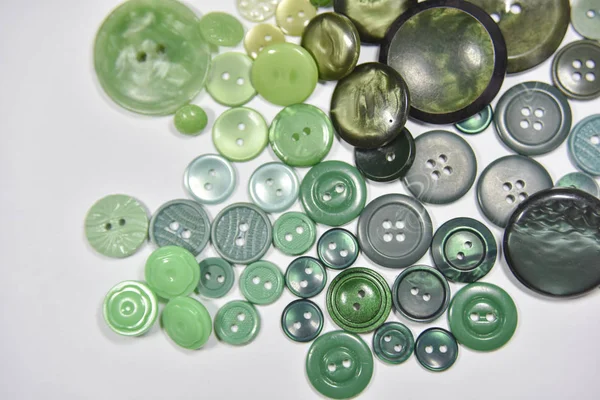 Green buttons of different shape and size on the white backgroun — 图库照片