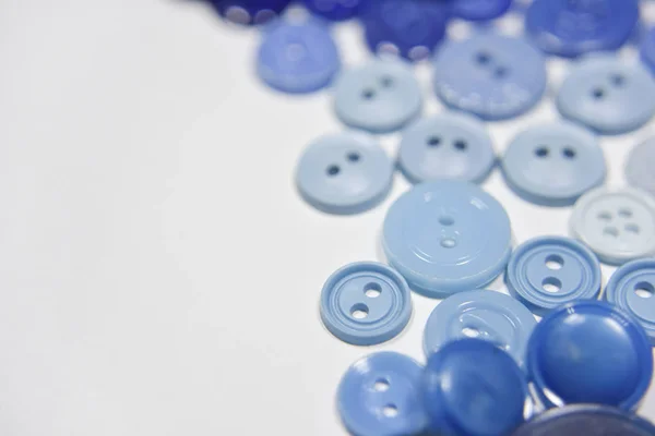 Blue buttons of different shape and size on the white background — 图库照片