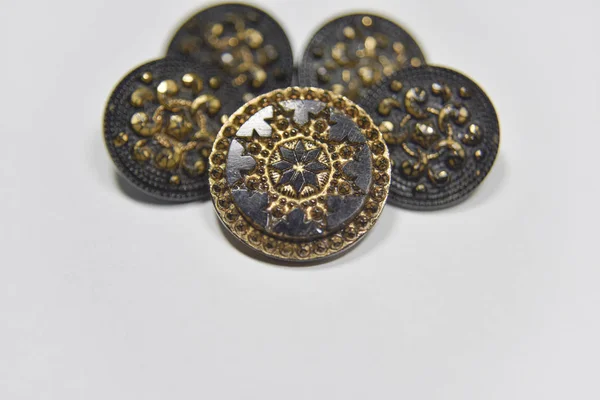 Black and golden ornamented buttons with floral mandala pattern 