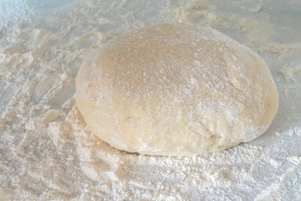 Piece Raw Dough Lies Table Some Flour Tightly Kneaded Piece — Stock Photo, Image