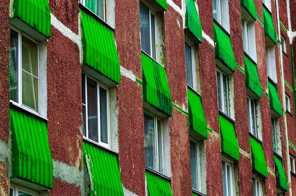 wall of an old house with green balconies. wall of an old house with green accents. background old building