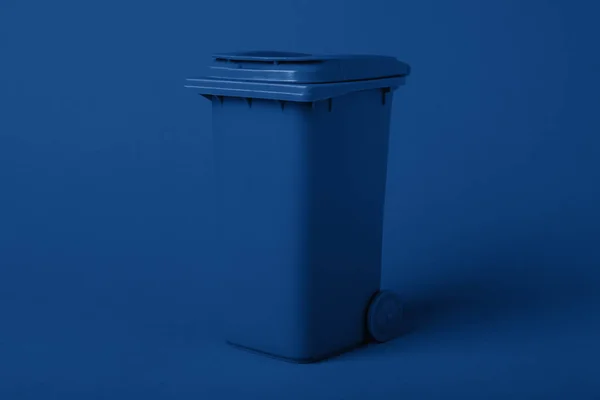 Recipiente de basura sobre un fondo azul, teñido en un color clásico azul de moda, tendencia 2020. Reciclaje — Foto de Stock