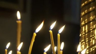 candles burn in the church camera with movement to the side
