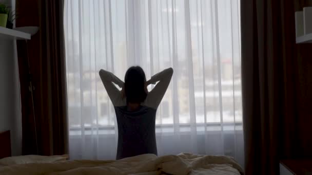 Girl wakes up stretches up and opens the window — Wideo stockowe