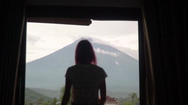 Dziewczyna otwiera zasłony widok na wulkan Agung na wyspie Bali — Wideo stockowe