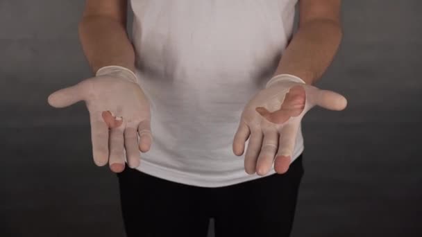 A man shows his hands in tattered gloves medical — Stock Video