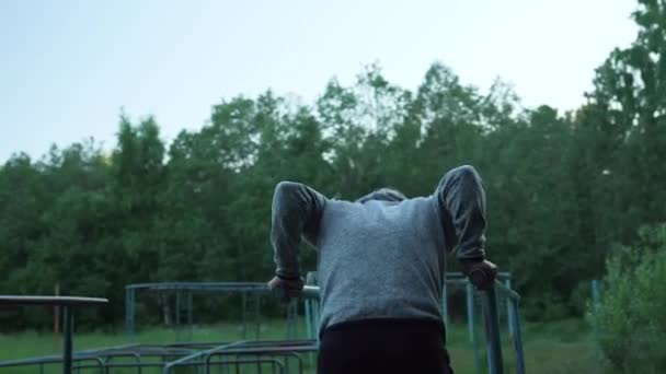 Un hombre practica deportes en el campo de deportes — Vídeo de stock