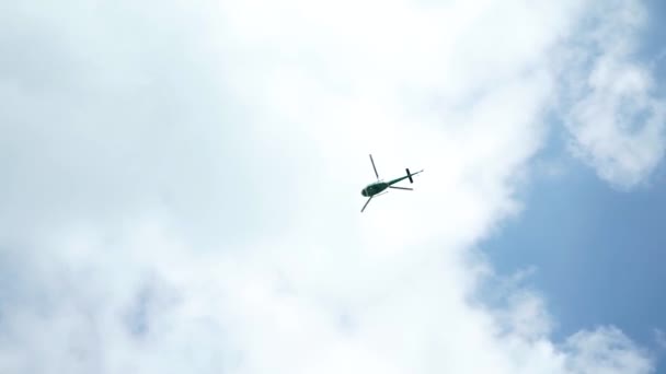 Helicopter flying in the blue sky with clouds — Stock Video