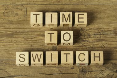 time to switch text on cubes on wooden background clipart