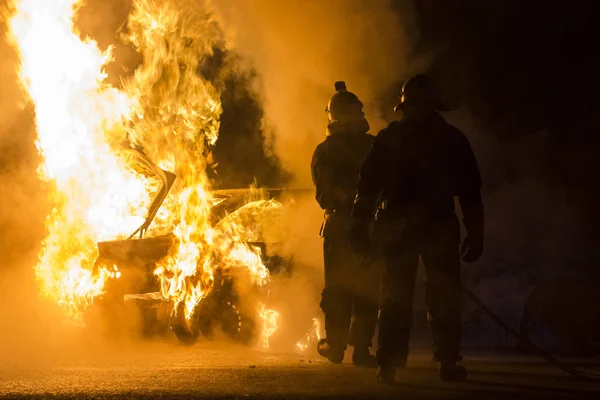 Burning car on the road in night — Stock Photo, Image