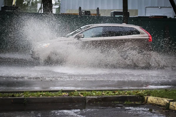 Car rides in heavy rain on a flooded road — Stock Photo, Image