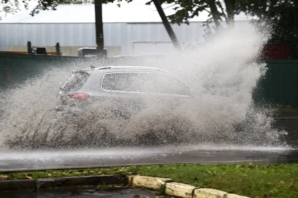 Car rides in heavy rain on a flooded road — Stock Photo, Image