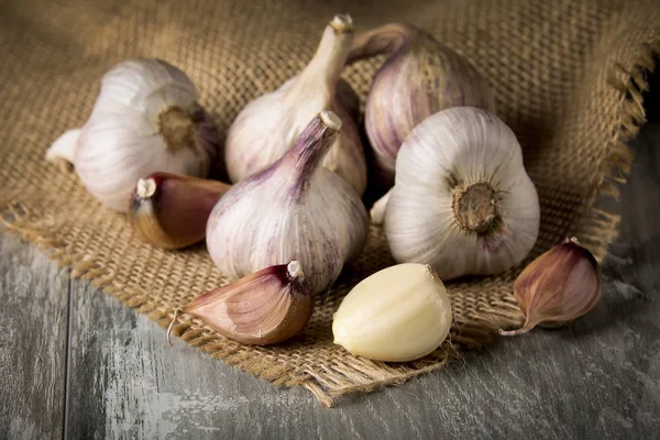 Close-up garlic bulbs and garlic cloves on wooden background. Garlic. Fresh garlic.