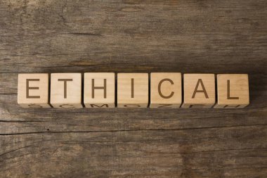ethical word written on wooden toy cubes clipart