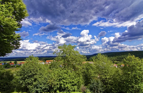 Beautiful sky with clouds over the city near the forest