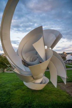 iron sculpture with meadow and sky