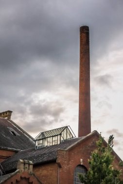 red brick chimney and glass house