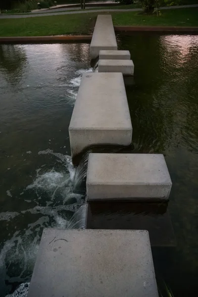 Concrete blocks in small river stream — Stockfoto