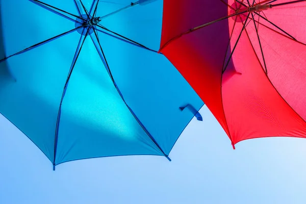 Two Colorful Umbrellas Background Sunny Clear Sky Expanding Blue Red — Stock Photo, Image