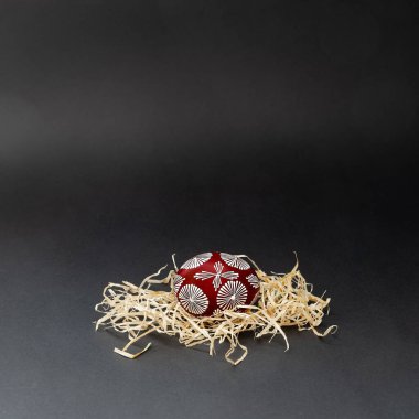 Litvanya 'nın geleneksel boyalı Paskalya yumurtasıyla saman üzerinde balmumu beyazı ve geometrik desenli braun eşliğinde minimum paskalya düzenlemesi. İzole edilmiş, siyah arkaplanda, boşluğu kopyala