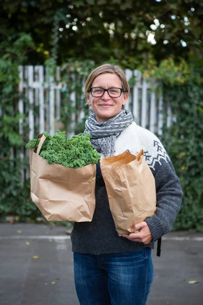 Woman Holding Paper Bag Filled Fresh Kale — Stock Photo, Image