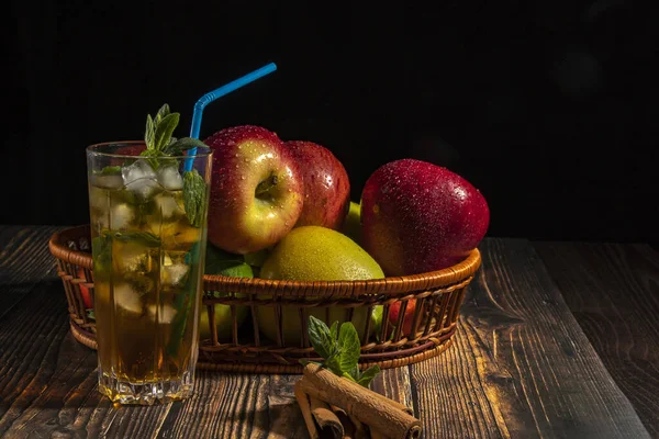 Apple cocktail with ice and mint. Bar concept  Apple mojito with mint and ice on a dark background.