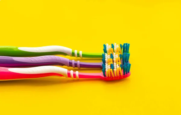 New Colored Plastic Toothbrushes Yellow Background Selective Focus — Stock Photo, Image