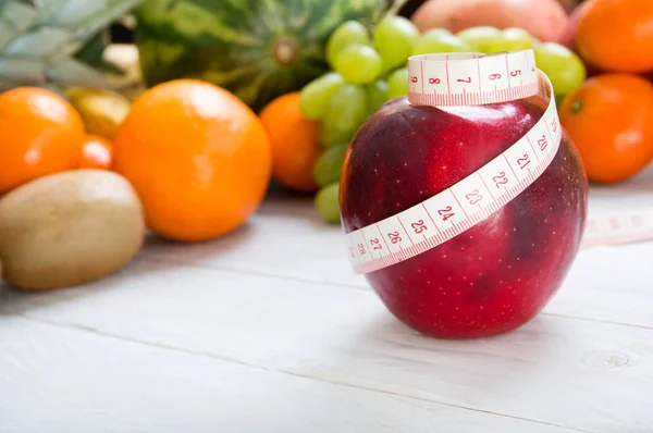 Elma ve meyveli arka plan üzerinde ölçüm bandı — Stok fotoğraf