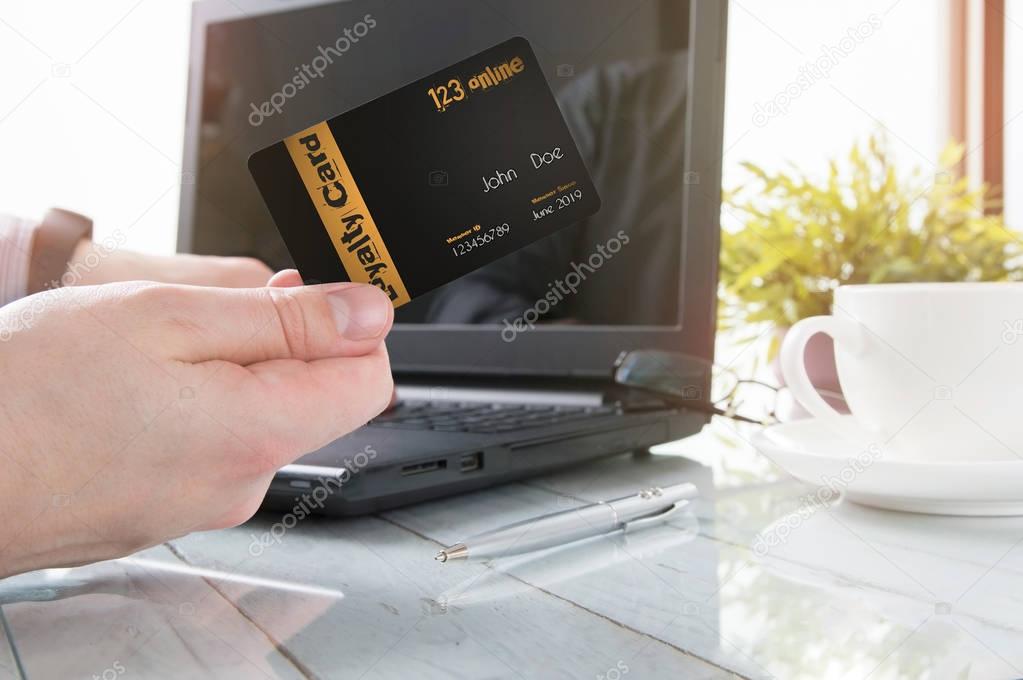 Man is holding a loyalty card while office working