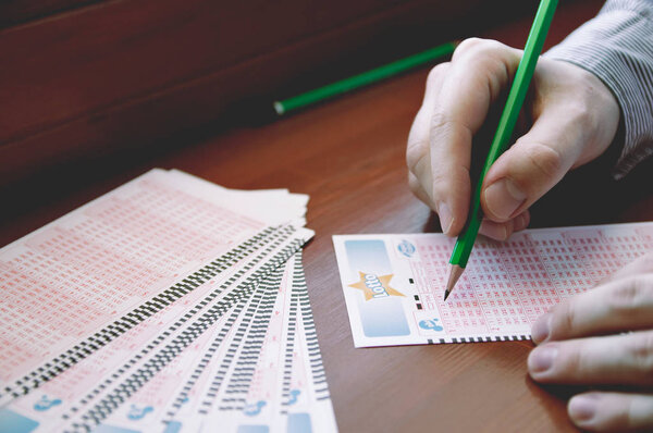 Man fill out a lotto lottery ticket.