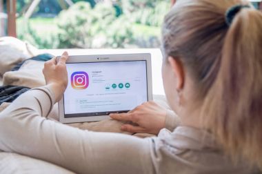 Kadın Lenovo tablet üzerinde Instagram uygulama yükleme.