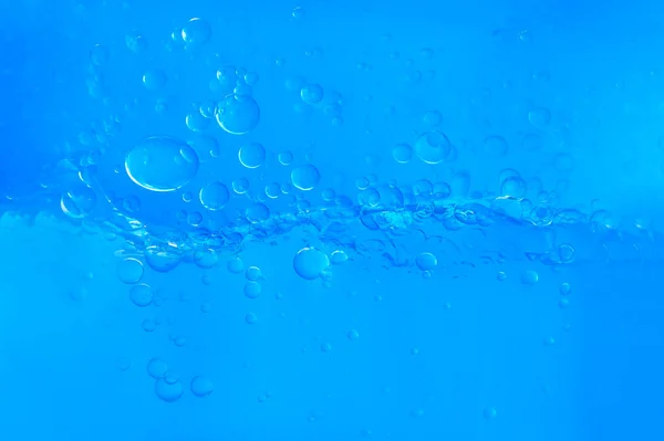 Agua azul con burbujas sobre fondo blanco — Foto de Stock