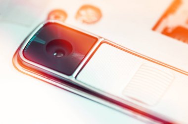 Beyaz smartphone içinde modern fotoğraf makinesinin yakın çekim. Kırmızı fl ile görüntü