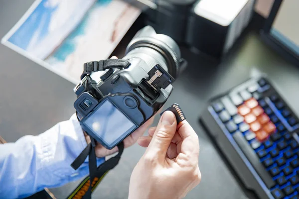 Fotógrafo pone la tarjeta de memoria en su cámara —  Fotos de Stock