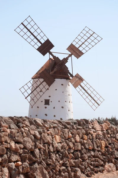 Fuerteventura, Canary Islands, Spain: desert landscape and countryside with the famous and traditional windmill in the village of El Roque, in the northwestern part of the island Stock Photo