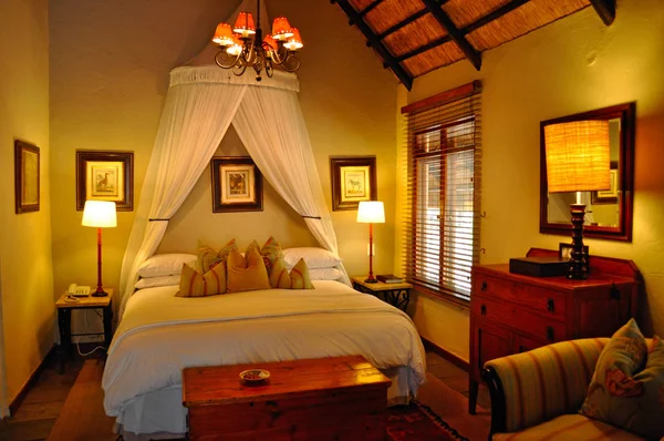 Safari in South Africa: a romantic bedroom at the Ngala Private Game Reserve, a luxury safari lodge located in the Kruger National Park, one of the largest game reserves in Africa since 1898, South Africa's first national park in 1926