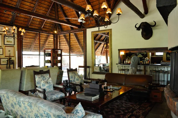 Safari in South Africa: sofas and chairs in the living room of Ngala Private Game Reserve, luxury safari lodge in the Kruger National Park, one of the largest game reserves in Africa since 1898, South Africa's first national park in 1926