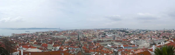 Португалия: горизонт Лиссабона с видом на красные крыши, дворцы Старого города, мост 25 апреля и реку Тагус — стоковое фото