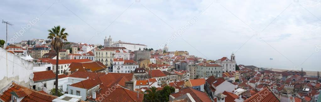 Portugal: the skyline of Lisbon with view of the red roofs, the palaces and the buildings of the Old City 