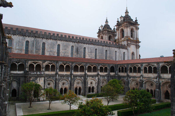 Portugal: orange trees and view of the Cloister of Silence of the medieval Roman Catholic monastery of Alcobaca, founded in 1153 by the first Portuguese King, Afonso Henriques