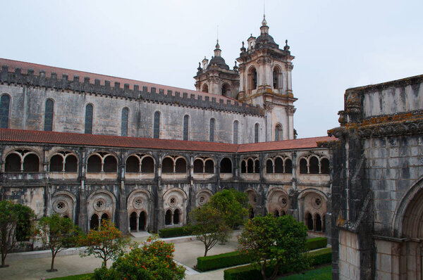 Portugal: orange trees and view of the Cloister of Silence of the medieval Roman Catholic monastery of Alcobaca, founded in 1153 by the first Portuguese King, Afonso Henriques