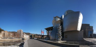 Spain: Guggenheim Museum Bilbao, the museum of modern and contemporary art designed by architect Frank Gehry, opened in 1997, with Tall Tree & The Eye, the 2009 sculpture by Anish Kapoor clipart