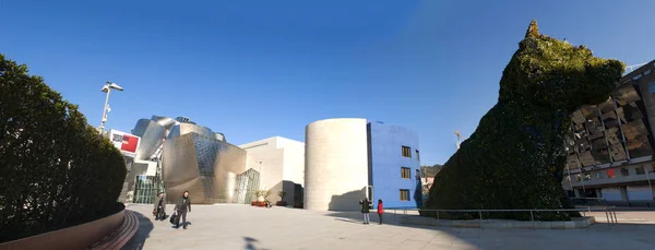 España: Museo Guggenheim Bilbao, el museo de arte moderno y contemporáneo diseñado por el arquitecto Frank Gehry, inaugurado en 1997, con la escultura de flores Puppy de Jeff Koons a la entrada — Foto de Stock