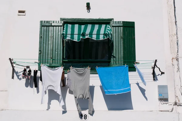A green window with laundry hanging to dry — Stock Photo, Image