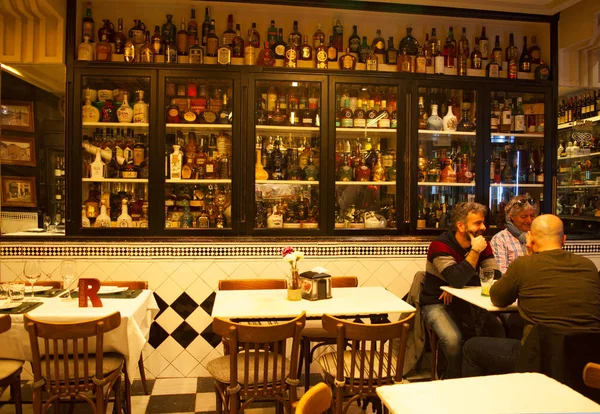 Bilbao, Spain: people sitting at a table in the Taberna Plaza Nueva, one of the most ancient and typical taverns and restaurants under the arches of Plaza Nueva, the famous square of the Old City — Stock Photo, Image