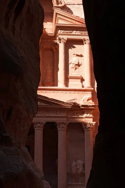 Jordanië: een glimp van Al-Khazneh, de Schatkist, één van de beroemdste tempels in de archeologische Nabataean stad Petra, gezien via de rotsen van de Siq, de hoofdingang canyon — Stockfoto