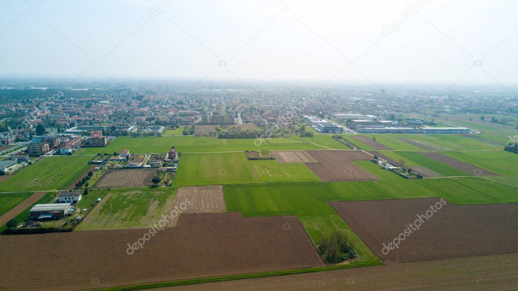 Nature and landscape, municipality of Cesate, Milano: Aerial view of a field, houses and homes, farming, grass green, countryside, farming, trees. Italy