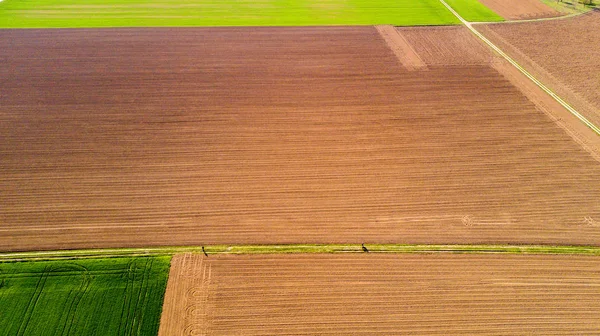 Natureza e paisagem: Vista aérea de um campo, cultivo, grama verde, campo, agricultura, estrada de terra — Fotografia de Stock