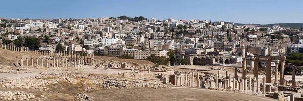 Jordan: the ruins of the Roman city of Gerasa,  one of the largest and most well preserved sites of Roman architecture in the world, and the skyline of modern Jerash in the background